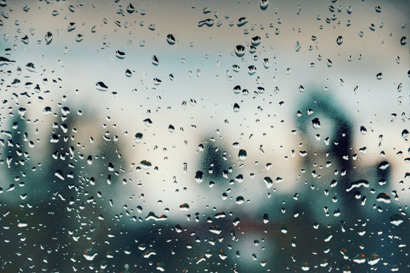 Water spotting across a pane of glass, obscuring the view beyond